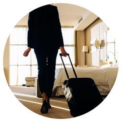 Woman walking with a suitcase in a commercial building