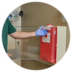 WM employee safely handling a sharps disposal container