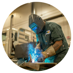 Welder in an industrial plant