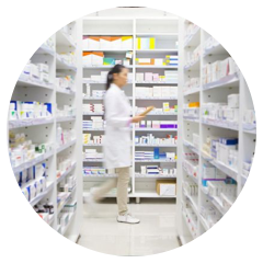 Pharmacy employee checking shelves for medication