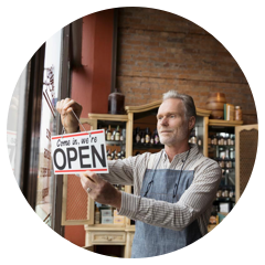 Retail shop employee putting up open sign